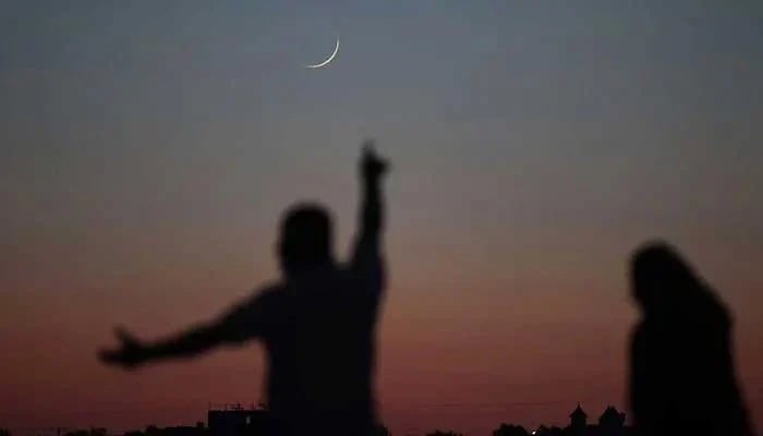 A man reacts after spotting the crescent in the sky. — AFP/File