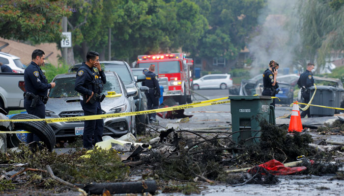 Emergency personnel work at the crash scene on a street, after a small civilian aircraft went down in a military neighbouhood in San Diego, California, US May 22, 2025. — Reuters