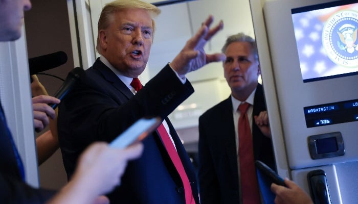 US President Donald Trump, with U.S. House Minority Leader Kevin McCarthy (R-CA), speaks to reporters aboard Air Force One while returning to Washington from Cape Canaveral, Florida, US. — Reuters/File