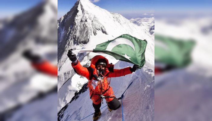 This undated image shows Pakistani mountaineer Naila Kiani raising the national flag after summiting a peak. — Reporter
