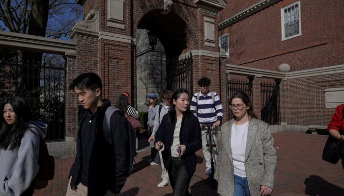 Students walk on the campus of Harvard University in Cambridge, Massachusetts, US, April 15, 2025. — Reuters