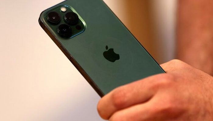 A customers holds the new green colour Apple iPhone 13 pro shortly after it went on sale inside the Apple Store on 5th Avenue in Manhattan in New York City, New York, U.S., March 18, 2022. — Reuters