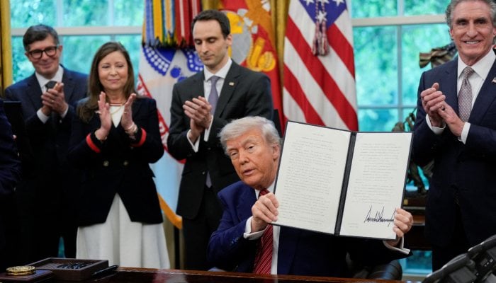 US President Donald Trump holds a signed executive order at the White House in Washington, DC, US, May 23, 2025. — Reuters