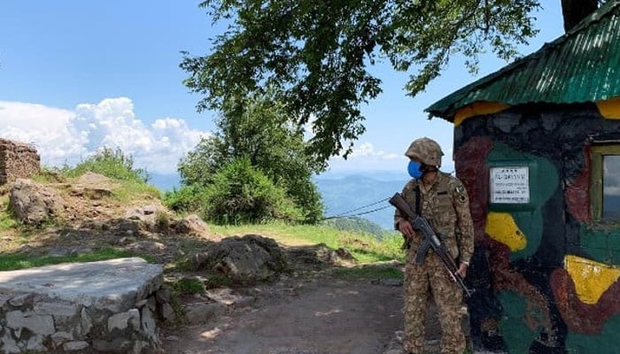 A soldier stands guard at a hilltop post near the Line of Control in Charikot Sector, Azad Kashmir on July 22, 2020. — Reuters