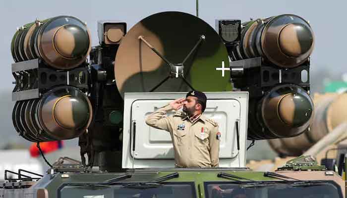 Pakistani Army soldier salutes while standing on an air defence missile system during Pakistan Day military parade in Islamabad, March 23, 2022.  — Reuters