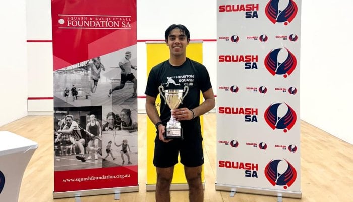 Pakistanz Ankan Erfan is released with the cup after winning the South Australian Squash Open. Correspondent