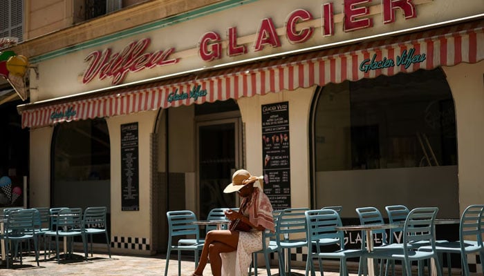 A woman sits at the terrace of a closed ice-cream shop following a major electricity outage, during the 78th Cannes Film Festival in Cannes, France May 24, 2025 — Reuters
