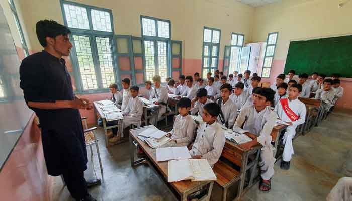 The image shows a teacher teaching students at a school. — Reuters/File