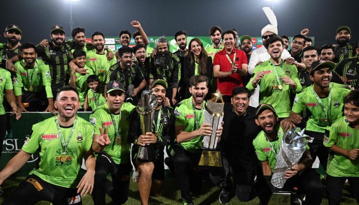 Lahore Qalanders captain Shaheen Shah Afridi (centre) holds the trophy as he celebrates with players during the victory ceremony at the end of the Pakistan Super League (PSL) T20 final cricket match against Quetta Gladiators at the Gaddafi Cricket Stadium in Lahore on May 25, 2025. — AFP
