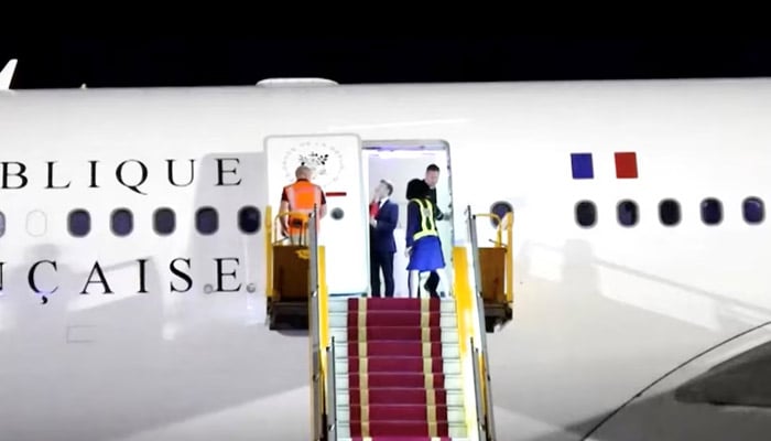French President Emmanuel Macron stands near the door of a plane, as a hand appears and pushes his face away, in Hanoi, Vietnam, May 25, 2025, in this screengrab from a video. — Reuters