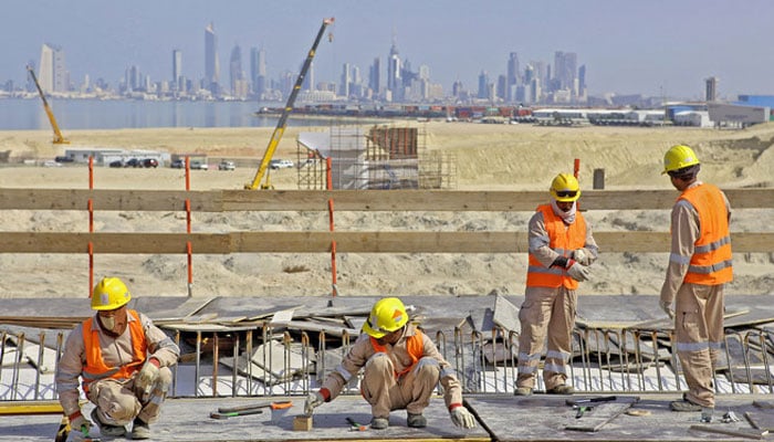 Laborers work at a construction site of the Sheikh Jaber Al-Ahmad Al-Sabah causeway in Kuwait City on Feb. 11, 2017. — AFP