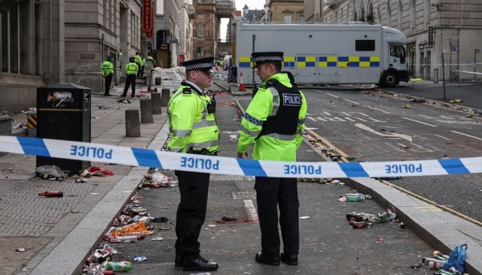 Police officers work at the scene after an incident where a car ploughed into a crowd of Liverpool fans during a parade celebrating their sides Premier League soccer title, in central Liverpool, Britain, May 27, 2025. — Reuters