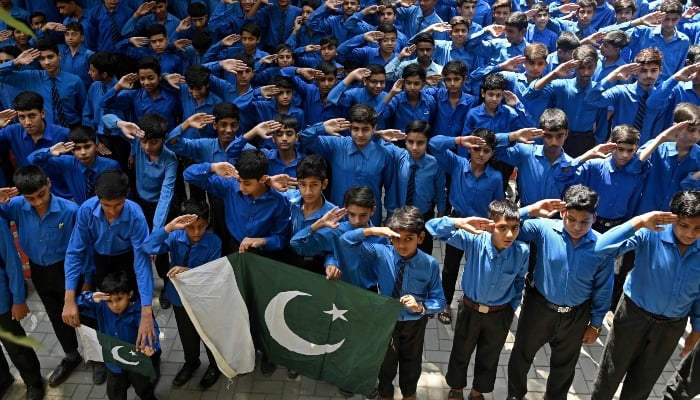 Students salute as they express solidarity with Pakistans armed forces during a school assembly in Lahore on May 12, 2025. — AFP