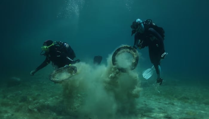 Volunteer divers gather waste from the bottom of the seabed, at the port of Votsi, off the island of Alonissos, Greece, May 24. — Reuters
