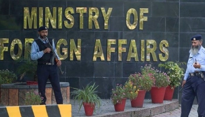 Two guards stand outside of the Ministry of Foreign Affairs office in Islamabad, Pakistan. — AFP