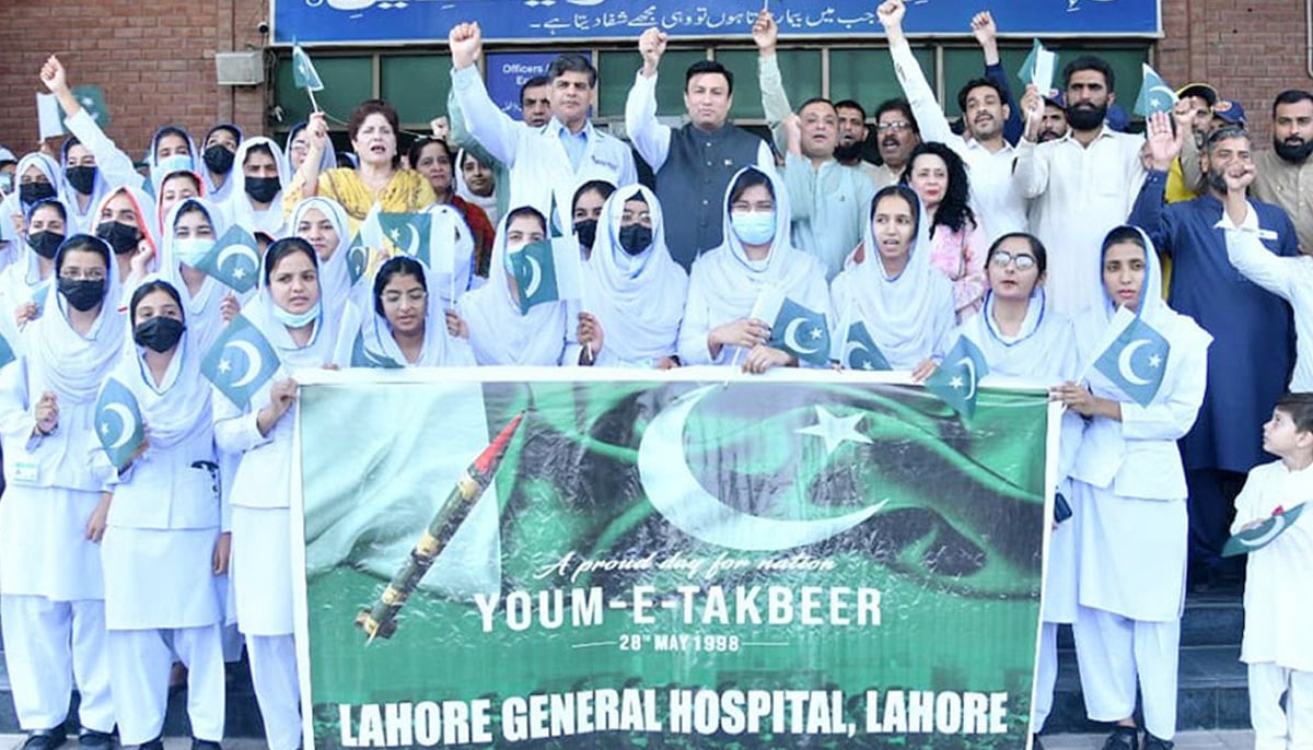 Participants of event related to Youm-e-Takbeer chanting slogans at General Hospital, Lahore. — NNI