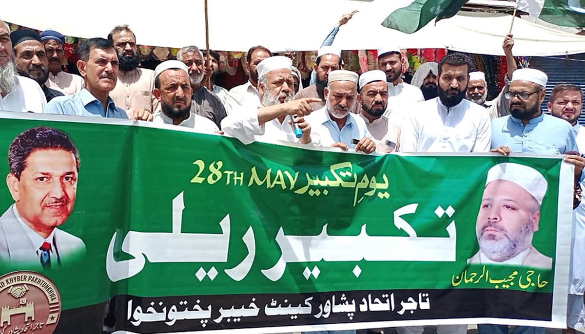 Activists of Tajir Ittehad Peshawar Cantt hold rally on occasion of Youm-e-Takbeer at Fawara Chowk, Peshawar. — INP