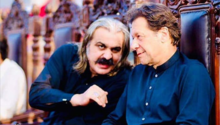 KP CM Ali Amin Gandapur (left) speaks to PTI founder Imran Khan during an event in this undated image. — X@AliAminKhanPTI