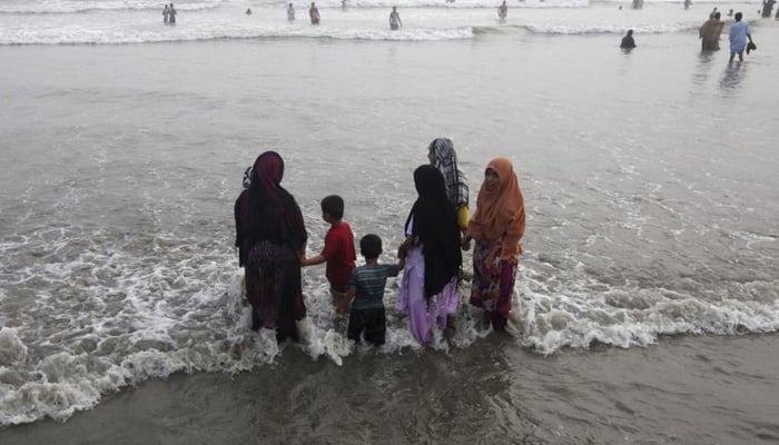 A family visits a beach during intense hot weather in Karachi, June 22, 2015. — Reuters
