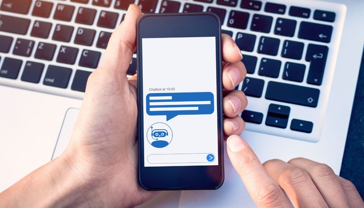 A representational image showing a person using a chatbot on their phone. — Canva