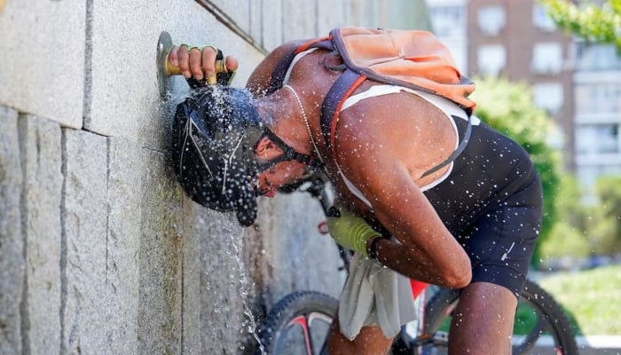A cyclist cools off at a fountain at Madrid Rio park during the second day of the heatwave, in Madrid, Spain, July 25, 2024. — Reuters