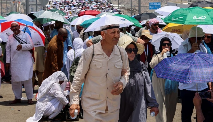 Pilgrims walk with umbrellas amid extremely hot weather, during the annual Hajj pilgrimage, in Mina, Saudi Arabia, June 18, 2024. — Reuters