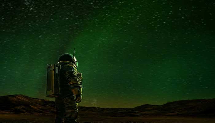 An artists concept shows an astronaut on the surface of Mars looking at a green aurora in the night sky. The illustration was obtained by Reuters on May 15, 2025. — Reuters\