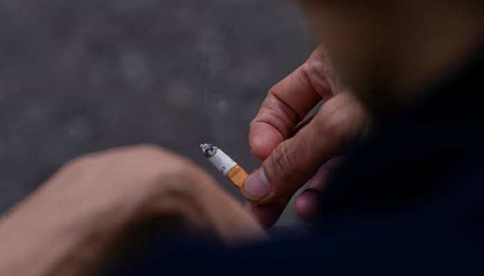 A man holds a cigarette in his hands in London, Britain April 11, 2023. — Reuters