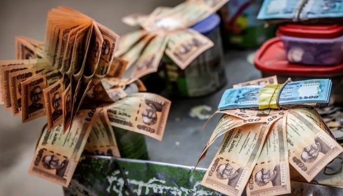 Bangladeshi taka notes featuring portraits of Sheikh Mujibur Rahman, the countrys founding father and parent of ousted Prime Minister Sheikh Hasina, are seen at a currency-trade stall in Old Dhaka on August 17, 2024. — AFP