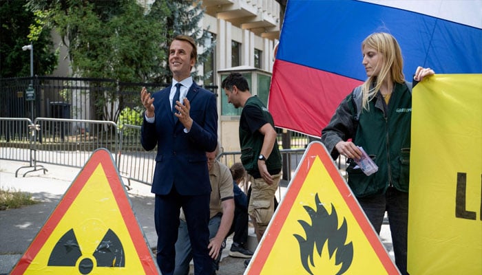 Greenpeace environmental activists set up a wax statue of French President Emmanuel Macron — they say they stole earlier at the Grevin Museum — during an action against Frances gas and fertiliser imports from Russia, outside the Russian Embassy in Paris on June 2, 2025 — AFP