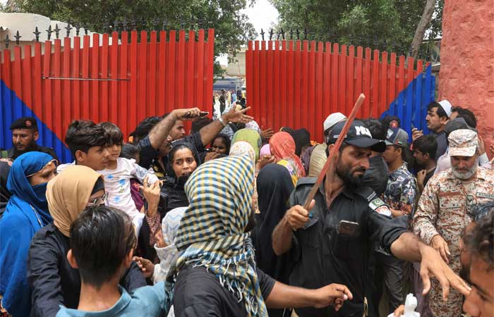 A police officer with a baton reacts as he disperses the family members of the prisoners, after dozens of prisoners escaped from the district Malir Jail, on the outskirts of Karachi, Pakistan, June 3, 2025. — Reuters