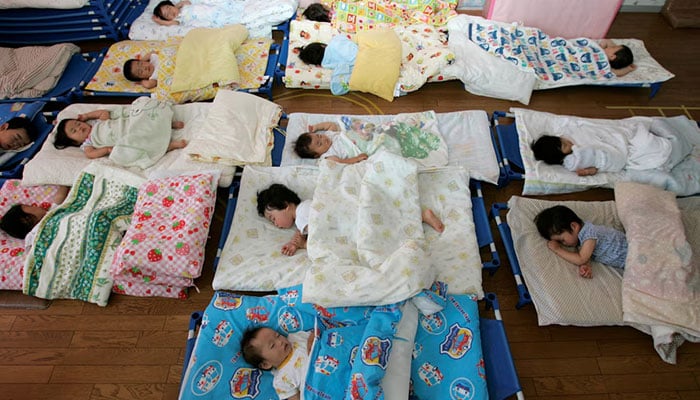 Nursery school children take a nap at Hinagiku nursery in Moriyama, western Japan. — Reuters/File