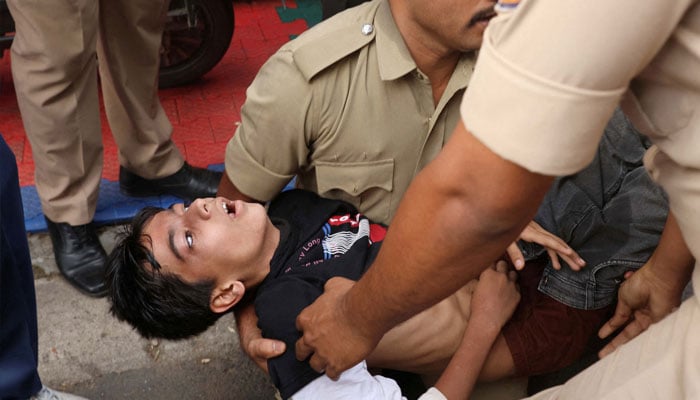 A boy lies unconscious following a stampede outside a cricket stadium in Bengaluru, India, June 4, 2025 — Reuters