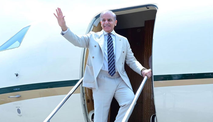 Prime Minister Shehbaz Sharif acts while getting on an airplane before Dushanbe airport, Dushanbe, Tadjikistan on May 30, 2025. - App