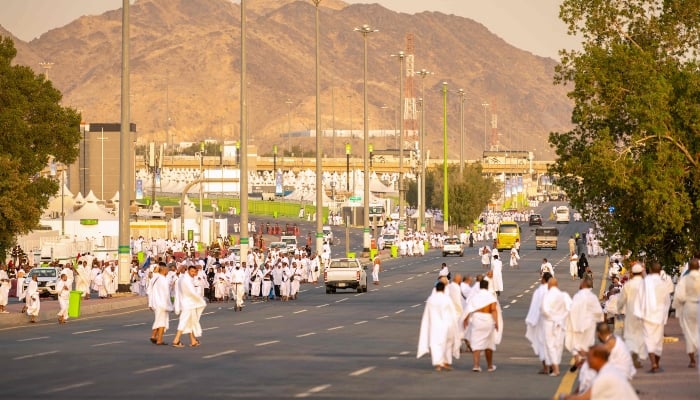 Pilgrims walk on a road in Mina near holy city of Makkah on June 4, 2025. — AFP
