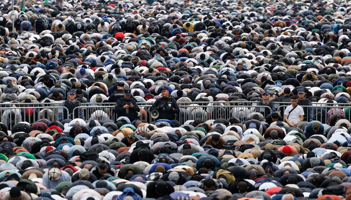 Law enforcement officers stand guard as people attend Eid ul Adha mass prayer, marking the end of the hajj pilgrimage near Moscows grand mosque in Russia, June 6, 2025. — Reuters