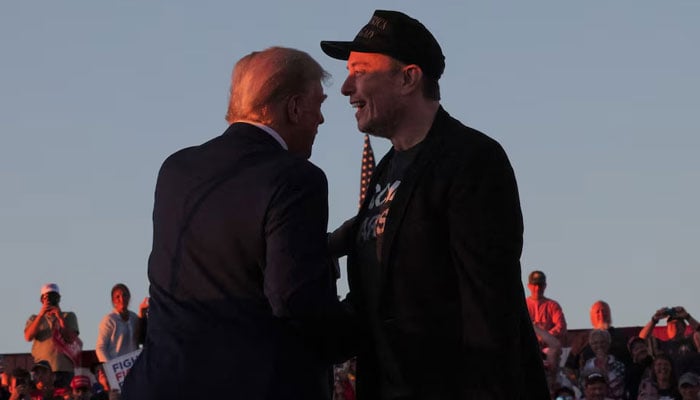 Tesla CEO and X owner Elon Musk stands with US President Donald Trump during a campaign rally, on the day Trump returns to the site of the July assassination attempt against him, in Butler, Pennsylvania, US, October 5, 2024. — Reuters