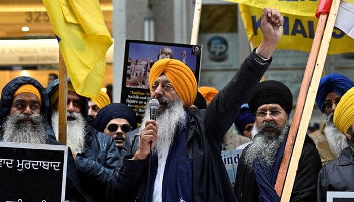 A demonstrator uses a microphone as others hold flags and signs as they protest outside Indias consulate, a week after Canadas former prime minister Justin Trudeau raised the prospect of New Delhis involvement in the murder of Sikh separatist leader Hardeep Singh Nijjar, in Vancouver, British Columbia, Canada September 25, 2023. — Reuters
