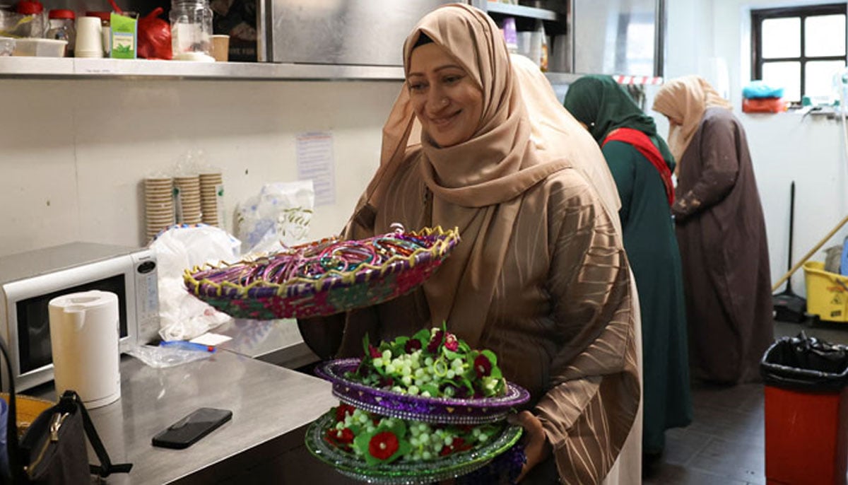 Volunteers from the Khizra mosque prepare lunch for refugees, as part of the Eid ul Adha celebrations in Manchester, Britain, June 7, 2025. — Reuters