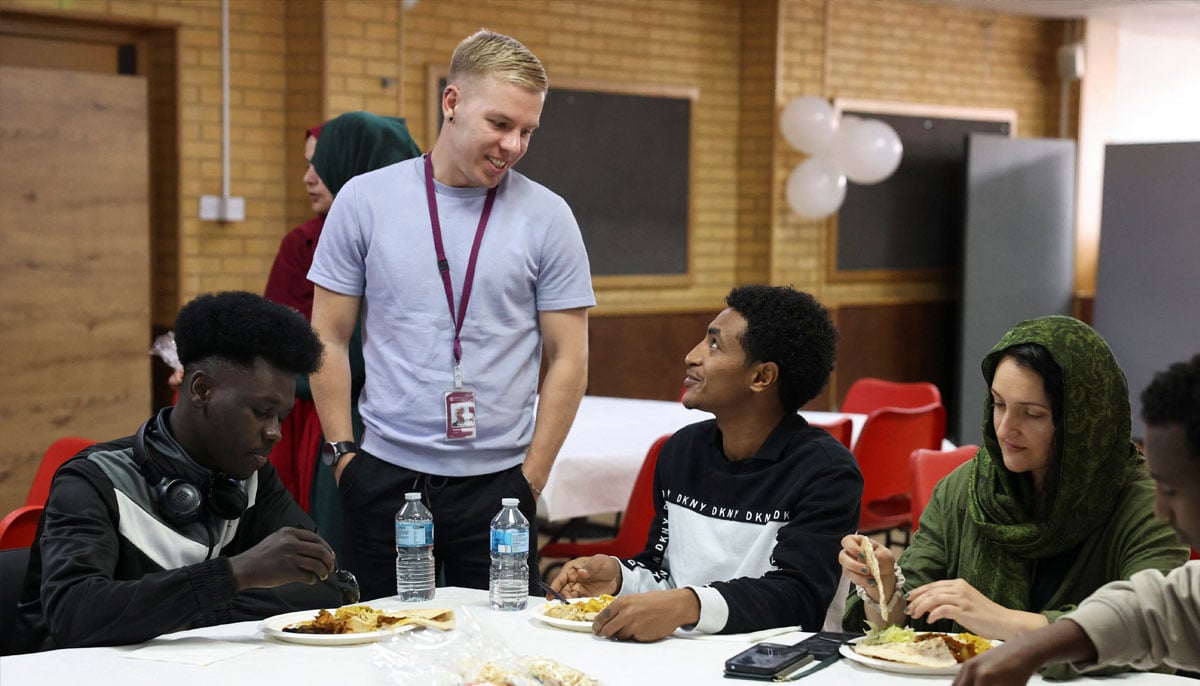 Refugees attend a lunch hosted by Khizra Mosque in Manchester as part of its Eid ul Adha celebrations, in Manchester, Britain, June 7, 2025. — Reuters