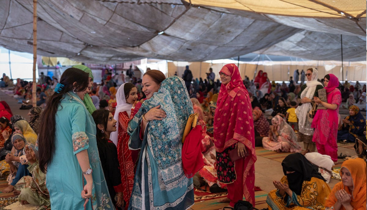 Women dressed in festive clothing embrace in celebration after Eid ul Adha prayer at the Badshahi Mosque in Lahore, June 7, 2025. — Reuters