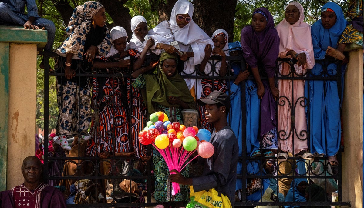 Girls buy balloons during the Muslim holiday of Eid ul Adha in Kano, Nigeria on June 6, 2025. — Reuters