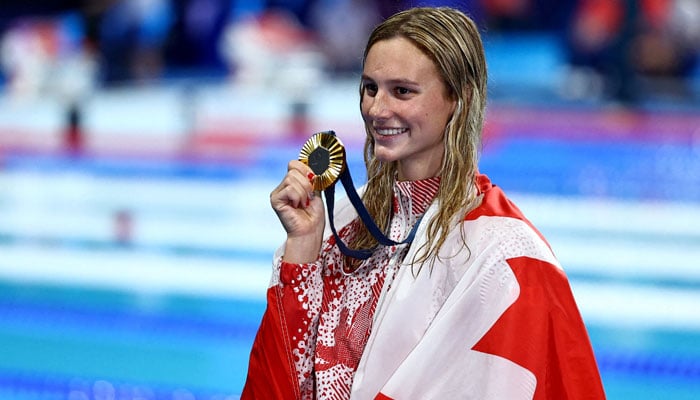 Gold medallist Summer McIntosh of Canada celebrates as shes poses with her medal after winning the womens 200m individual medley at Paris 2024 Olympics for Womens 200m Ind. Medley Victory Ceremony at Paris La Defense Arena, Nanterre, France on August 3, 2024. — Reuters