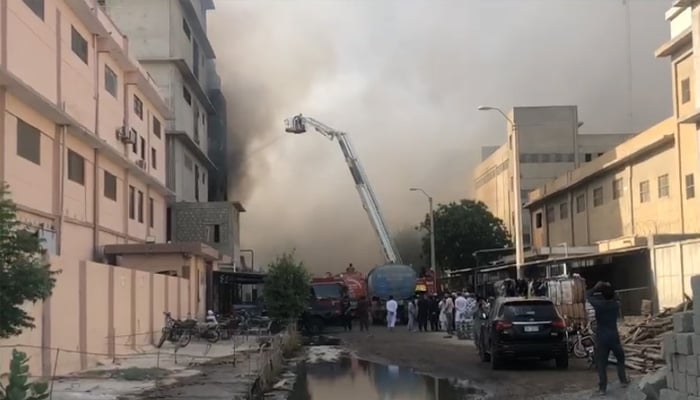 Firefighters using a snorkel at the site of factory fire in Landhi export processing zone, Karachi, on June 8, 2025. — Screengrab via Geo News