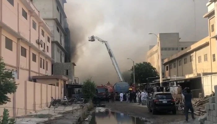Firefighters using a snorkel at the site of factory fire in Landhi export processing zone, Karachi, on June 8, 2025. — Screengrab via Geo News