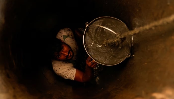 A man cleans out a small well in Chandrapur, India, February 3, 2025. — Reuters