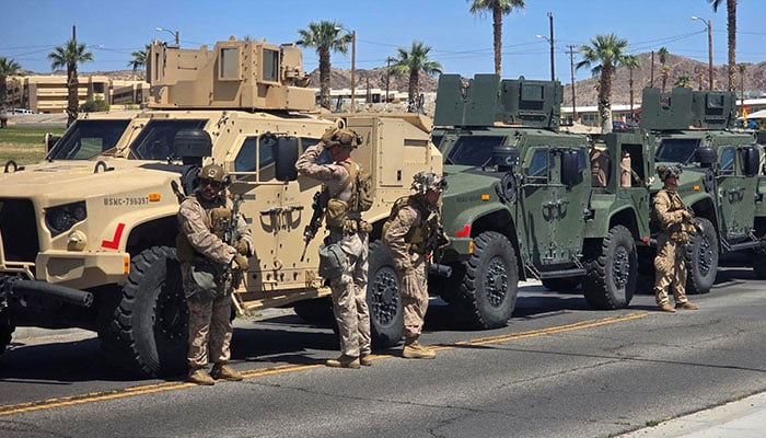 Marines stand near vehicles as they prepare to depart for Los Angeles, at an unknown location, in this handout picture released on June 9, 2025. — Reuters