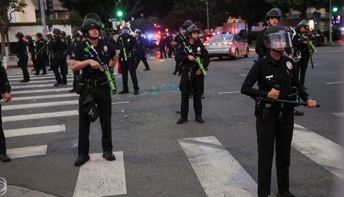 Members of law enforcement carrying non-lethal weapons stand guard, as protests against federal immigration sweeps continue, in downtown Los Angeles, California, US on June 10, 2025. — Reuters