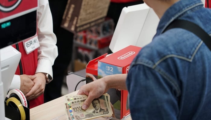 A customers purchases Nintendo Switch 2 at an electronics retailer in Tokyo on June 5, 2025. — AFP