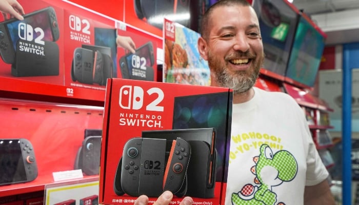 A French customer living in Tokyo smiles as he shows off a Nintendo Switch 2 bought at an electronics retailer in Tokyo on June 5, 2025. — AFP
